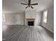 Bright living room featuring wood-look floors, fireplace, and a ceiling fan with recessed lighting at 39 N Rowsham Pl, Smithfield, NC 27577