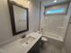 Clean secondary bathroom featuring tiled floors and tub/shower combo at 40 Bailey-Boykin Rd, Selma, NC 27576