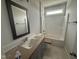 Bathroom with a combination tub/shower and a gray vanity at 40 Bailey-Boykin Rd, Selma, NC 27576