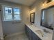 Bright bathroom with double sink vanity, grey cabinets and a window for natural light at 40 Bailey-Boykin Rd, Selma, NC 27576