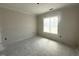 Bright bedroom featuring neutral walls, white trim, and a large window at 40 Bailey-Boykin Rd, Selma, NC 27576