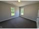 Cozy bedroom with neutral paint, plush carpet, and plenty of natural light at 40 Bailey-Boykin Rd, Selma, NC 27576