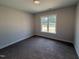 Bedroom with neutral walls, carpeted floor, and a window with a view of the neighborhood at 40 Bailey-Boykin Rd, Selma, NC 27576