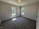 Inviting bedroom featuring two windows offering ample natural light, and cozy carpet flooring for comfort at 40 Bailey-Boykin Rd, Selma, NC 27576