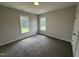 Carpeted bedroom featuring natural light from two windows at 40 Bailey-Boykin Rd, Selma, NC 27576
