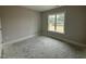 Simple bedroom filled with natural light from a large window, offering a comfortable and serene atmosphere at 40 Bailey-Boykin Rd, Selma, NC 27576