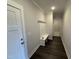 Functional entryway featuring coat hooks, a bench, and dark wood flooring at 40 Bailey-Boykin Rd, Selma, NC 27576