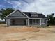 Charming single-story home boasts an attached two-car garage and a covered front porch at 40 Bailey-Boykin Rd, Selma, NC 27576