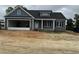 Charming blue home with gray stone accents, a garage, and covered porch for a modern and inviting feel at 40 Bailey-Boykin Rd, Selma, NC 27576