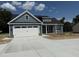 Charming new construction featuring a two-car garage and stylish gray siding at 40 Bailey-Boykin Rd, Selma, NC 27576
