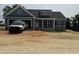 Charming home featuring blue siding, stone accents, attached garage, and a welcoming front porch at 40 Bailey-Boykin Rd, Selma, NC 27576