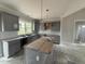 Elegant gray kitchen with granite countertops, central island, and stylish pendant lighting offering modern appeal at 40 Bailey-Boykin Rd, Selma, NC 27576