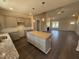Open-concept kitchen showcasing a center island, modern cabinets, granite countertops, and stylish pendant lighting at 40 Bailey-Boykin Rd, Selma, NC 27576
