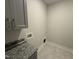 Spacious laundry room featuring granite countertop and upper cabinets at 40 Bailey-Boykin Rd, Selma, NC 27576