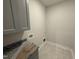 Well-lit laundry room with gray cabinets, granite countertop space, and convenient washer/dryer hookups at 40 Bailey-Boykin Rd, Selma, NC 27576