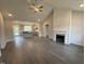 Spacious living room featuring wood floors, a vaulted ceiling, and fireplace, flowing into a modern kitchen at 40 Bailey-Boykin Rd, Selma, NC 27576