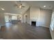 Spacious living room featuring a shiplap fireplace, vaulted ceiling, and hardwood floors, flowing into the kitchen at 40 Bailey-Boykin Rd, Selma, NC 27576