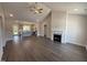 Bright open-concept living room featuring fireplace, ceiling fan, and hardwood floors at 40 Bailey-Boykin Rd, Selma, NC 27576