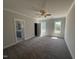 Bright main bedroom with large windows and adjoining bathroom access, featuring neutral paint and carpet flooring at 40 Bailey-Boykin Rd, Selma, NC 27576