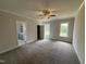 Spacious main bedroom with plush carpet, a ceiling fan, and an ensuite bathroom at 40 Bailey-Boykin Rd, Selma, NC 27576