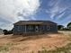 Newly constructed home features a covered back porch and blue siding at 40 Bailey-Boykin Rd, Selma, NC 27576