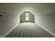 Finished attic space features plush carpeting and a window that provides natural light at 40 Tuskeegee Dr, Smithfield, NC 27577