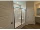 Bright bathroom featuring a walk-in shower with glass doors and a modern vanity at 40 Tuskeegee Dr, Smithfield, NC 27577