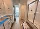 Bathroom with double vanity, walk-in shower, and walk-in closet, offering convenience and modern style at 40 Tuskeegee Dr, Smithfield, NC 27577