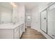 This bathroom features a sleek double sink vanity, wood floors and a glass door shower at 40 Tuskeegee Dr, Smithfield, NC 27577