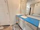 Bathroom vanity featuring white cabinetry, solid surface countertop and modern fixtures at 40 Tuskeegee Dr, Smithfield, NC 27577