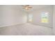 Bright, carpeted bedroom featuring neutral walls and two large windows at 40 Tuskeegee Dr, Smithfield, NC 27577