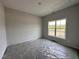 Cozy bedroom with neutral walls, plush carpeting, and a bright window, ideal for relaxation at 40 Tuskeegee Dr, Smithfield, NC 27577
