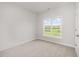 A bright bedroom features neutral walls and large window showing green outdoor space at 40 Tuskeegee Dr, Smithfield, NC 27577