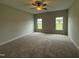 Spacious bedroom with plush carpet and natural light from dual windows at 40 Tuskeegee Dr, Smithfield, NC 27577