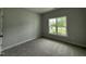 Neutral bedroom with carpeted floors and natural light from a single window at 40 Tuskeegee Dr, Smithfield, NC 27577