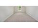 Bonus room features carpeted floors, neutral walls, and a large window at 40 Tuskeegee Dr, Smithfield, NC 27577