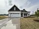 Charming new construction home featuring a two-car garage, black accents, and a well-manicured lawn at 40 Tuskeegee Dr, Smithfield, NC 27577