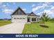 Charming home with white siding, black accents, and a well-manicured lawn at 40 Tuskeegee Dr, Smithfield, NC 27577