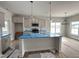 Modern kitchen featuring stainless steel appliances, a center island, pendant lighting, and bright windows at 40 Tuskeegee Dr, Smithfield, NC 27577
