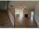 Bright, open-concept living space with modern flooring, fireplace, and staircase leading upstairs at 40 Tuskeegee Dr, Smithfield, NC 27577