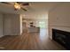 Open-concept living space with fireplace, ceiling fan, and views into kitchen at 40 Tuskeegee Dr, Smithfield, NC 27577