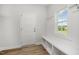 Charming mudroom features built-in bench with storage, coat hooks, and natural light at 40 Tuskeegee Dr, Smithfield, NC 27577