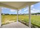 Covered patio area overlooking expansive backyard and neighboring homes under a blue sky at 40 Tuskeegee Dr, Smithfield, NC 27577