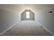 A spacious attic with a window, offering potential for storage or conversion into a cozy living area at 41 W Emily Gardens Dr, Selma, NC 27576