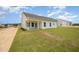 A view of the backyard, patio, and exterior of the house, showing construction in the surrounding area at 41 W Emily Gardens Dr, Selma, NC 27576