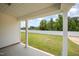 View of the expansive backyard, enclosed by a white fence and lush green trees from the back porch at 41 W Emily Gardens Dr, Selma, NC 27576