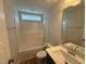 Clean bathroom featuring a white vanity and shower over tub and hard wood style flooring at 41 W Emily Gardens Dr, Selma, NC 27576