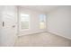 Comfortable bedroom featuring neutral carpeting, two bright windows, and a closet at 41 W Emily Gardens Dr, Selma, NC 27576