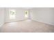 Bedroom featuring carpet, light walls, and windows overlooking the side yard at 41 W Emily Gardens Dr, Selma, NC 27576