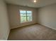 Bright bedroom with carpet, one window and light neutral walls for versatile decorating options at 41 W Emily Gardens Dr, Selma, NC 27576